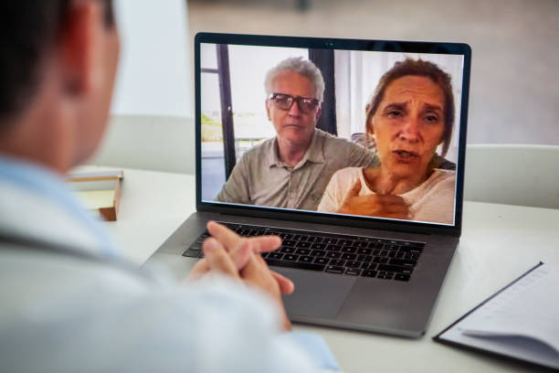 istock Doctor having video call with mature couple 1293418538