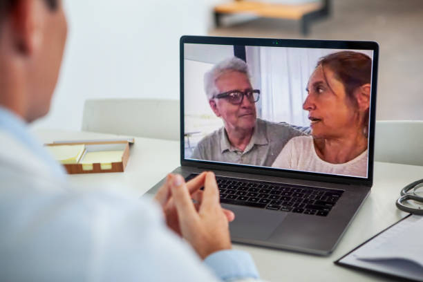 istock Doctor connected with mature couple thru laptop 1293418548