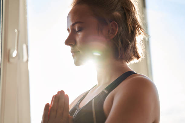 istock Woman keeping hands in namaste gesture 1293419705