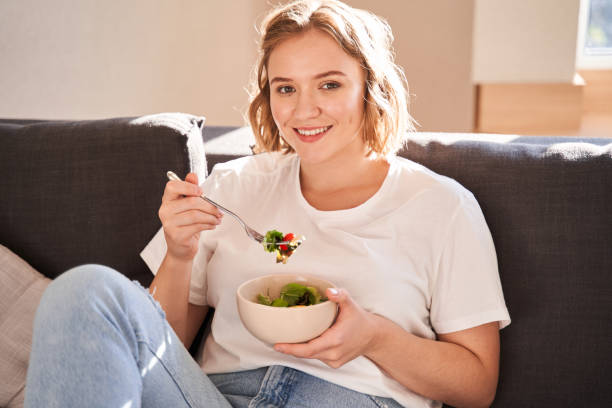istock Woman eating fresh salad 1293419741