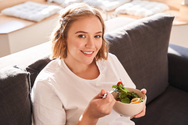 istock Woman holding plate with salad 1293419749