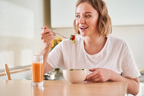 istock Woman tasting fresh salad 1293419762