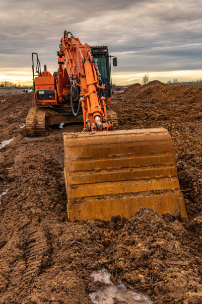 istock Excavator  doing work on a wet and muddy winter day 1293421304