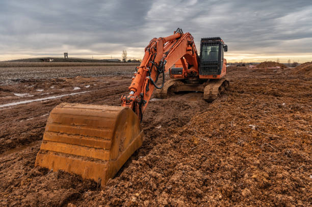 istock Excavator  doing work on a wet and muddy winter day 1293421305