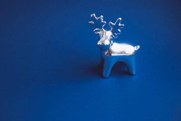 istock New Year's shiny toy deer on a bright blue background 1293421308