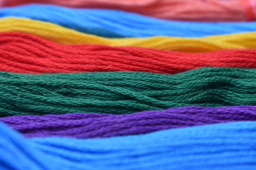 Bright multicolored thread set used for embroidery. Colourful vibrant engaging popping cheerful rainbow coloured threads