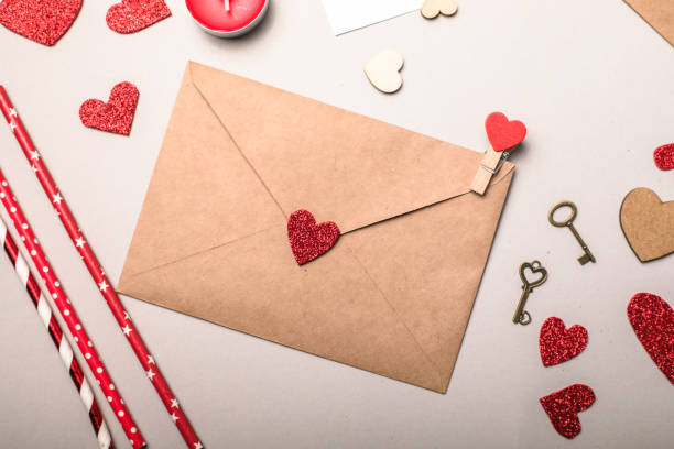 istock Paper envelope with Valentines hearts on gray background. Flat lay, top view. Romantic love letter for Valentine's day concept. 1293430515
