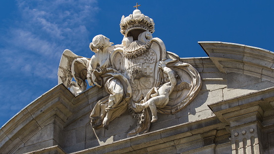 Sculpture on the top of The Puerta de Alcala timelapse (Alcala Gate) with flowers and traffic is a Neo-classical monument in the Plaza de la Independencia (Independence Square) in Madrid, Spain.