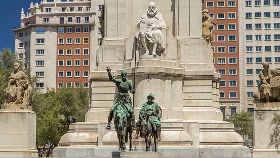 View of the stone sculpture of Miguel de Cervantes timelapse and bronze sculptures of Don Quixote and Sancho Panza on the Square of Spain (Plaza de Espana). Madrid is a popular tourist destination of Europe.