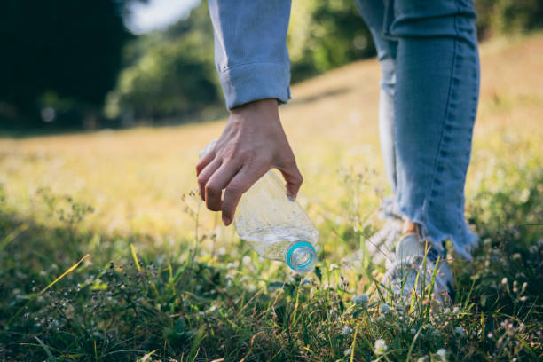 istock Woman hand holding garbage bottle plastic putting into recycle bag for cleaning 1293432002
