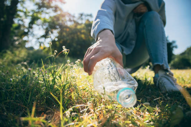 istock Woman hand holding garbage bottle plastic putting into recycle bag for cleaning 1293432021