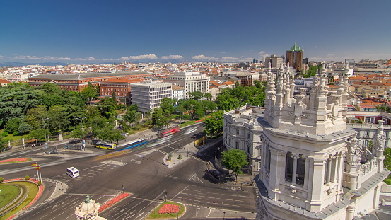 Aerial view of Cibeles fountain at Plaza de Cibeles in Madrid timelapse with traffic on circle in a beautiful summer day from Cibeles Palace, Spain