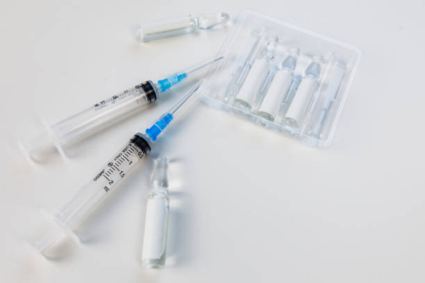 istock view of syringe with vaccine ampoules 1293432317