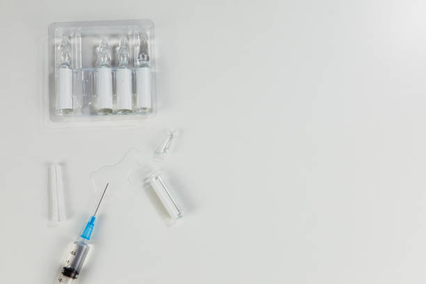 istock view of syringe with vaccine ampoules 1293432631