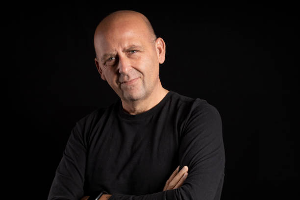 istock portrait middle aged man with light eyes on black background 1293432844