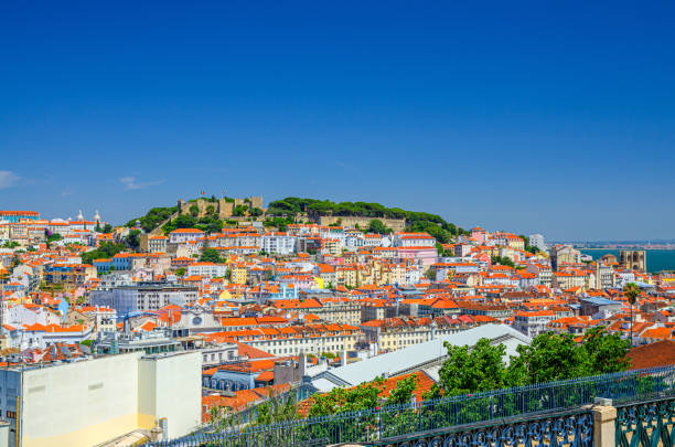 Lisbon cityscape, aerial panoramic view of Lisboa historical city centre with colorful buildings red tiled roofs, Sao Jorge Castle stock photo