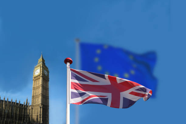 brexit concept. the english or great britain flag waving in front of a blurred eu european union flag. - british flag freedom photography english flag imagens e fotografias de stock