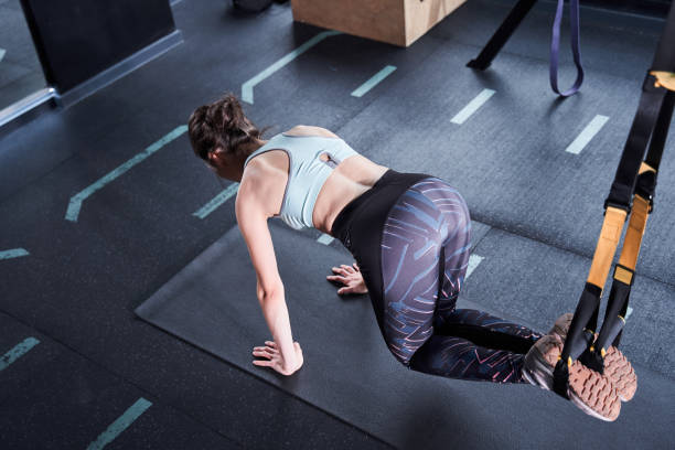 istock Woman working with TRX equipment 1293436413