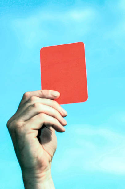 istock holding up the red card 1293437791