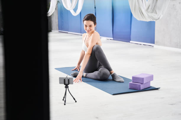 istock Woman sitting on the mat and stretching her legs 1293437897