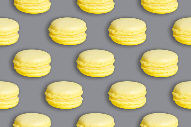 istock Ultimate yellow macarons on an Ultimate gray background 2021 color pattern 1293442117