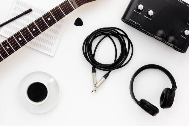 Musician work set with guitar, note and headphones