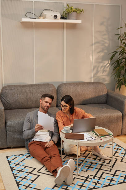 istock Modern Couple Working at Home Together 1293444522