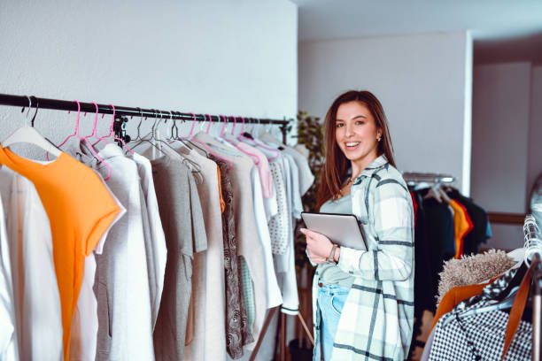 istock Online Clothing Store Vendor Showing Her Merchandise 1293444703
