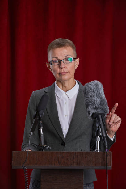 istock Mature Woman Giving Speech on Stage 1293444859