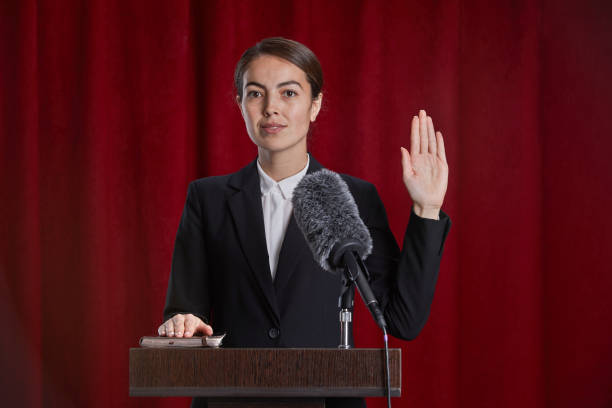 istock Young Woman Giving Oath on Stage 1293444871