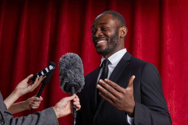 istock Smiling African-American Man Giving Interview to Journalists 1293444881
