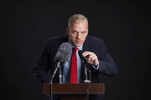 istock Mature Man Giving Speech at Podium 1293444882