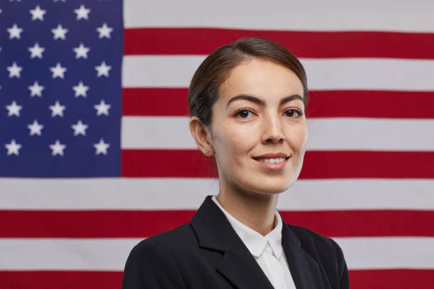 istock Smiling Female Leader against American Flag 1293444899
