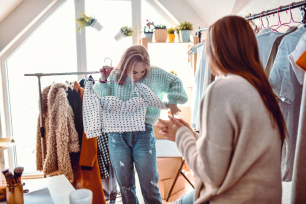 istock Customer Checking Shirt Top Fit With Help Of Shop Assistant 1293445044