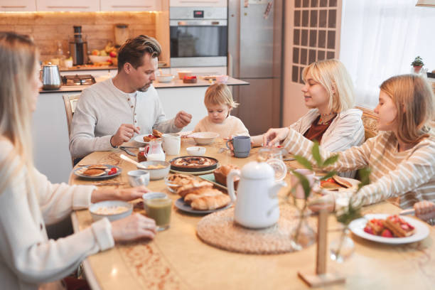 istock Big Family Enjoying Breakfast in Kitchen 1293445995