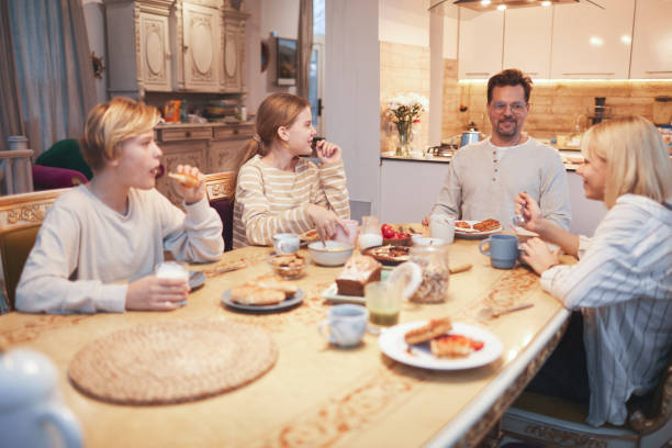 istock Big Family at Dinner Table in Kitchen 1293446001