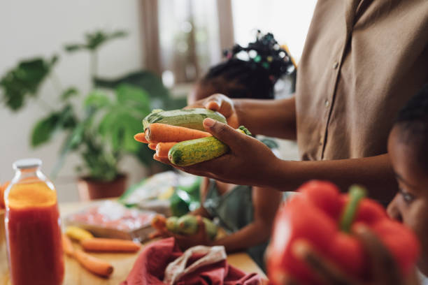 Anonymous Mother, Daughter and Son Preparing Vegetables for Lunch at a Kitchen Table