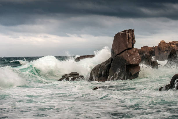 istock Powerful waves crashes in rocky coastline 1293446735