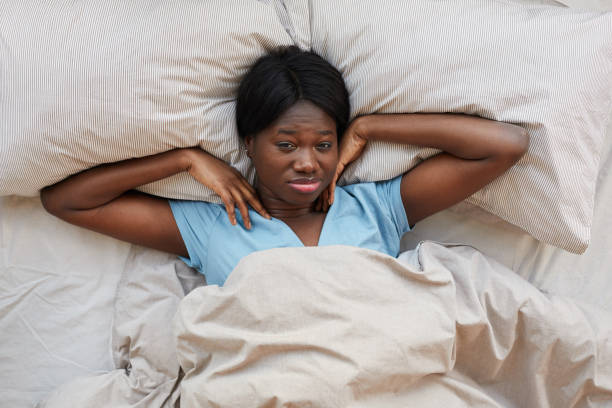 istock African-American Woman Stretching in Bed 1293446925