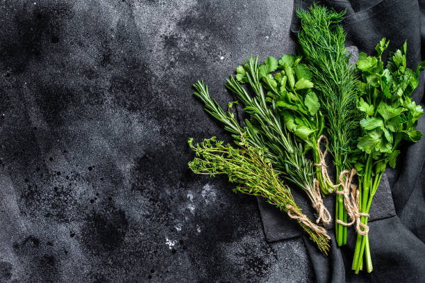 istock Organic fresh herbs coriander, rosemary, thyme, dill, parsley. Black background. Top view. Copy space 1293447934