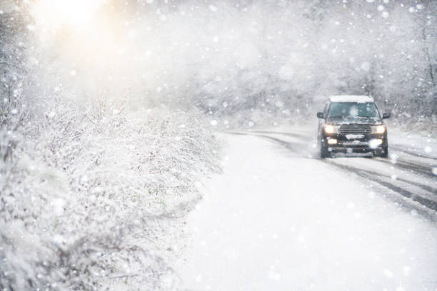 istock The car is driving on a winter road in a blizzard. 1293451568