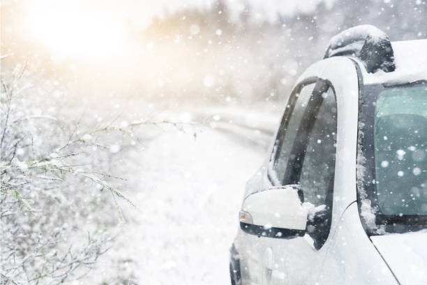 istock The car is driving on a winter road in a blizzard. 1293451645