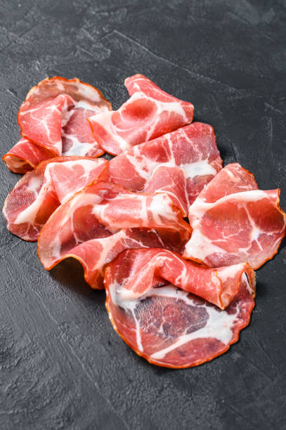 istock Coppa, Capocollo, Capicollo meat.  Black background. Top view 1293451920