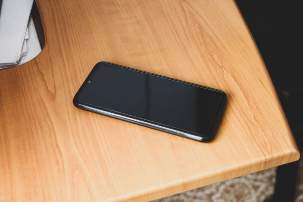 istock Smartphone lies on a wooden table 1293451991