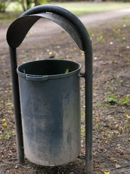 istock Vertical closeup shot of an empty public trash can in a park 1293452818