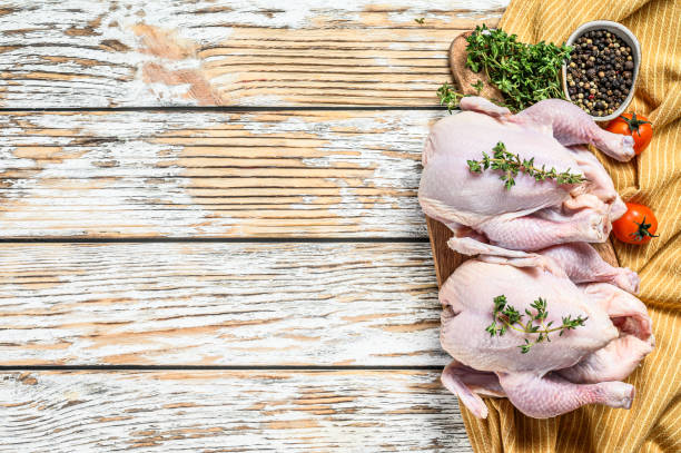 istock Whole raw Free range chicken with thyme and spices. White background. Top view. Copy space 1293452870