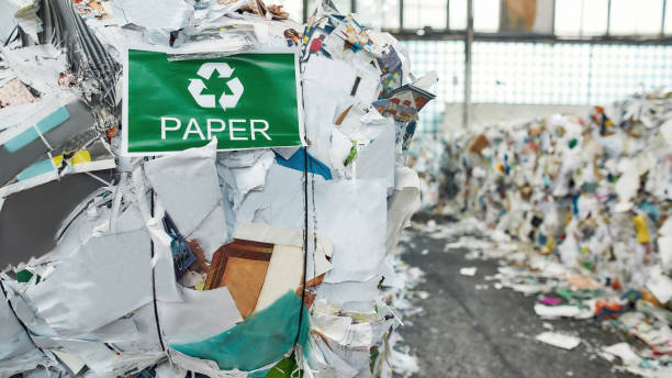 istock Recycling sign on banner on waste paper 1293456881