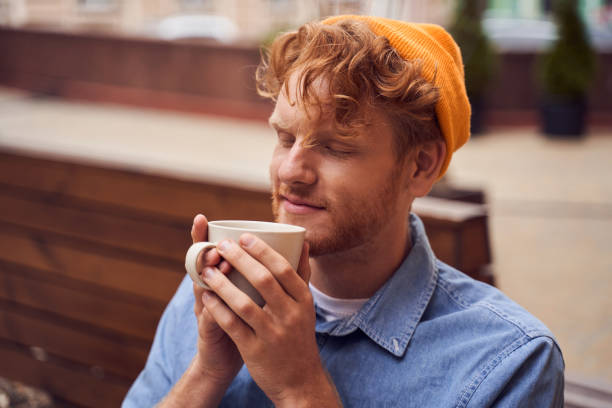istock Close up portrait of handsome man drinking coffee 1293458475
