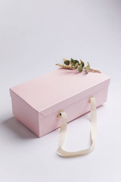 istock Pink gift box with a decoration plant 1293459476