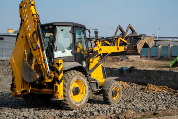 istock Yellow wheel loader Excavator machine working at construction site with a sand and gravel. Preparing of the fundament for a asphalting. Road construction site. Building of a parking. 1293460692